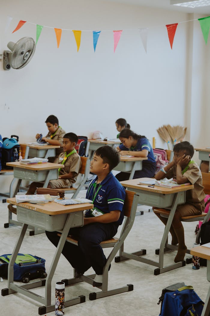 Children focusing on a lesson in a well-organized classroom setting.